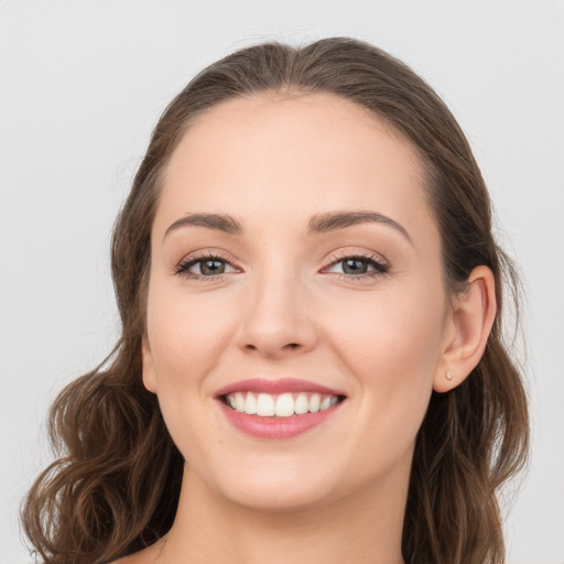 Joyful white young-adult female with long  brown hair and grey eyes