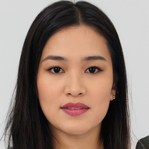 Joyful asian young-adult female with long  black hair and brown eyes
