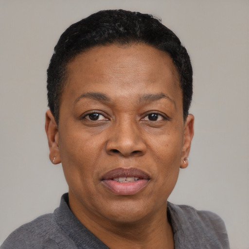 Joyful black adult female with short  black hair and brown eyes