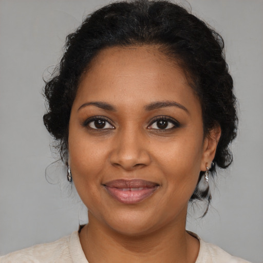 Joyful black young-adult female with medium  brown hair and brown eyes