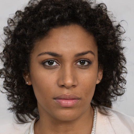 Neutral black young-adult female with medium  brown hair and brown eyes