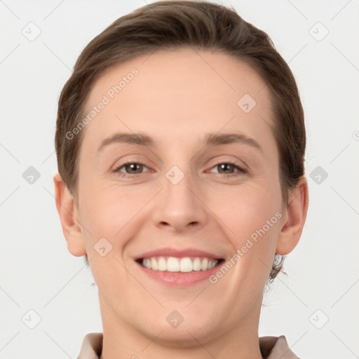 Joyful white young-adult female with short  brown hair and grey eyes