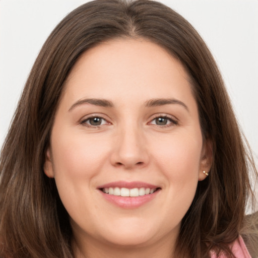 Joyful white young-adult female with long  brown hair and brown eyes