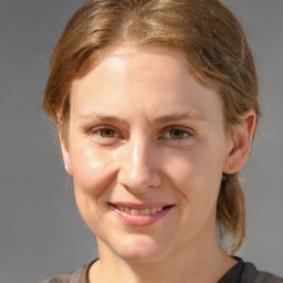 Joyful white young-adult female with medium  brown hair and grey eyes