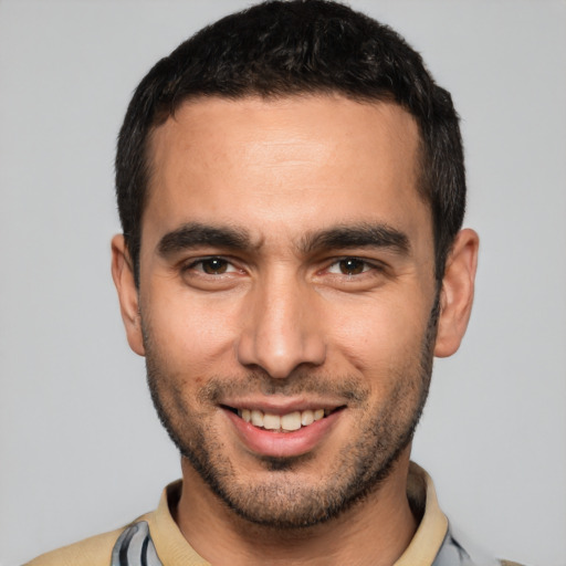 Joyful white young-adult male with short  black hair and brown eyes