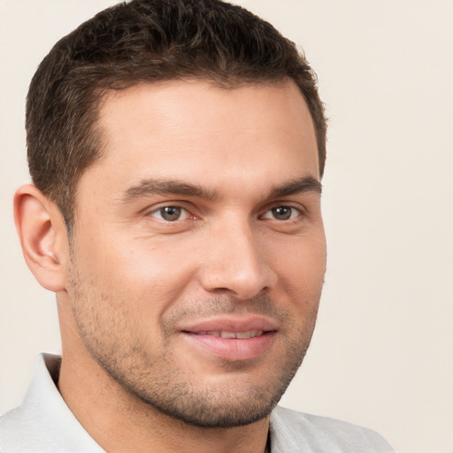 Joyful white young-adult male with short  brown hair and brown eyes