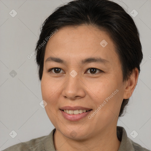 Joyful asian adult female with medium  brown hair and brown eyes