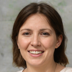 Joyful white adult female with medium  brown hair and brown eyes