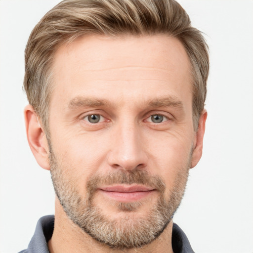 Joyful white adult male with short  brown hair and grey eyes