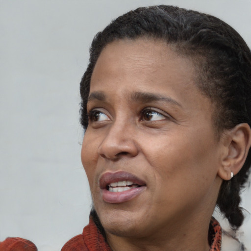 Joyful black adult female with short  brown hair and brown eyes