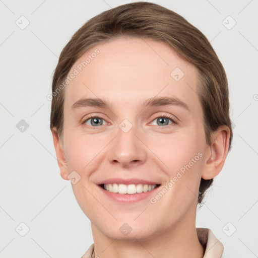 Joyful white young-adult female with short  brown hair and grey eyes