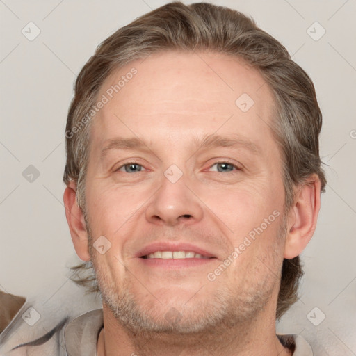 Joyful white adult male with short  brown hair and grey eyes