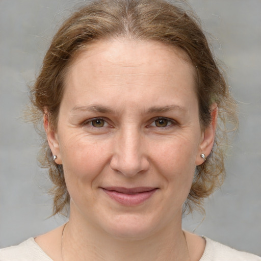 Joyful white adult female with medium  brown hair and grey eyes