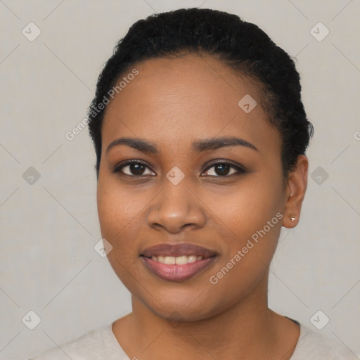 Joyful black young-adult female with short  black hair and brown eyes