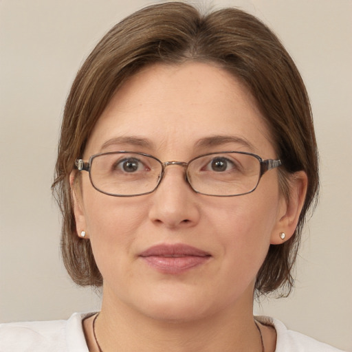 Joyful white adult female with medium  brown hair and brown eyes