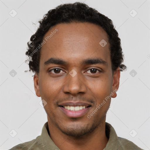 Joyful black young-adult male with short  black hair and brown eyes