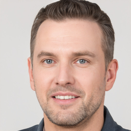 Joyful white young-adult male with short  brown hair and brown eyes