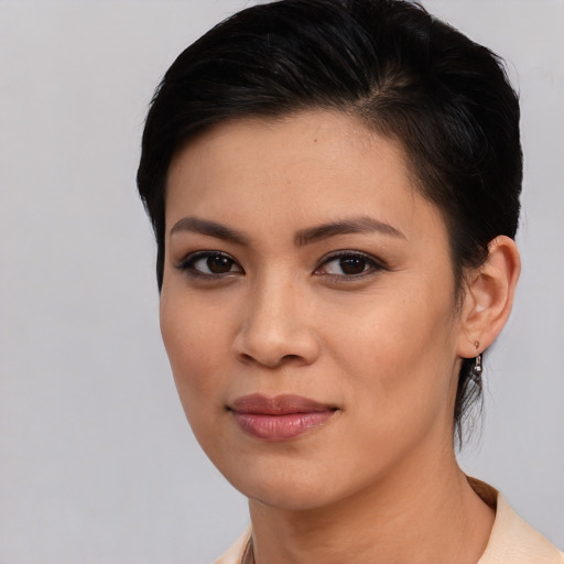 Joyful asian young-adult female with medium  brown hair and brown eyes