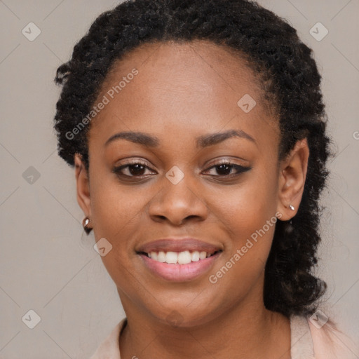 Joyful black young-adult female with long  black hair and brown eyes