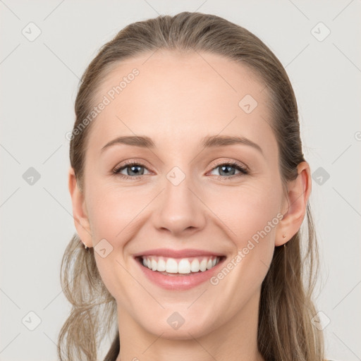 Joyful white young-adult female with long  brown hair and grey eyes