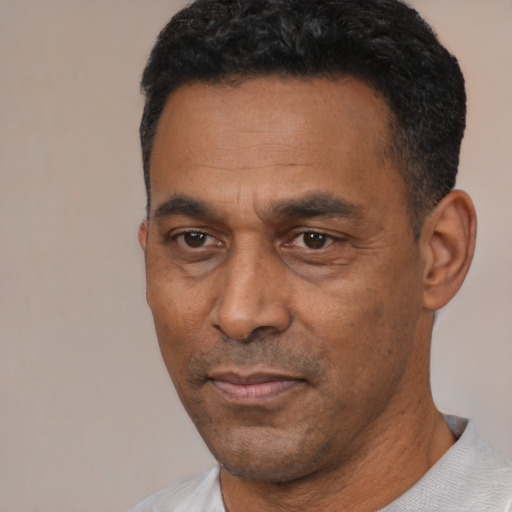 Neutral latino adult male with short  black hair and brown eyes