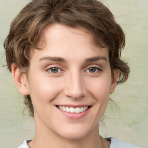 Joyful white young-adult female with medium  brown hair and green eyes