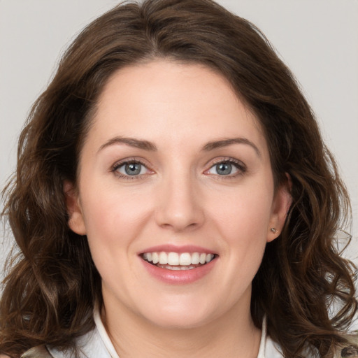 Joyful white young-adult female with medium  brown hair and green eyes