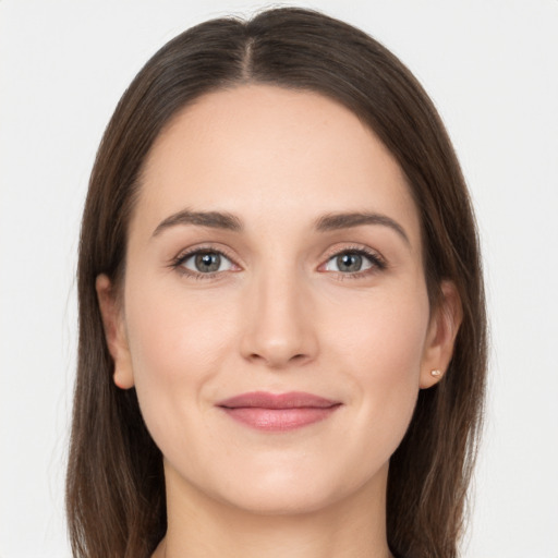 Joyful white young-adult female with long  brown hair and grey eyes