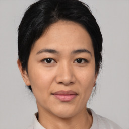 Joyful asian young-adult female with short  black hair and brown eyes