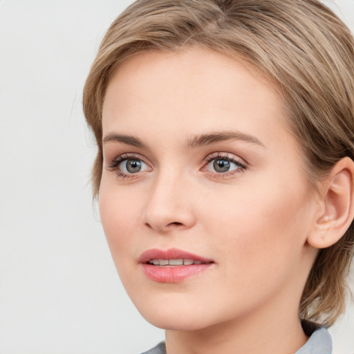 Joyful white young-adult female with medium  brown hair and blue eyes