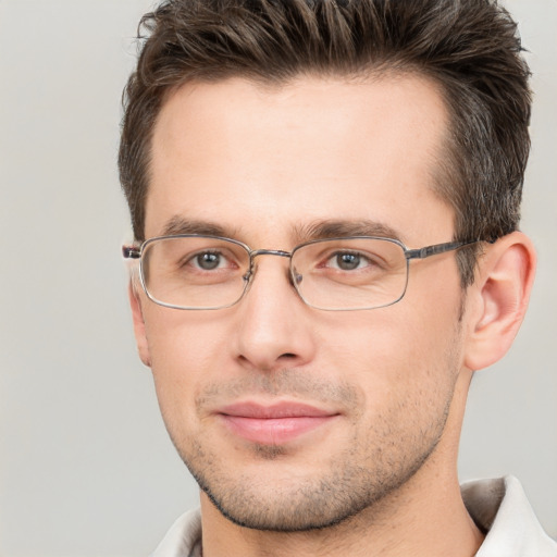 Joyful white adult male with short  brown hair and brown eyes