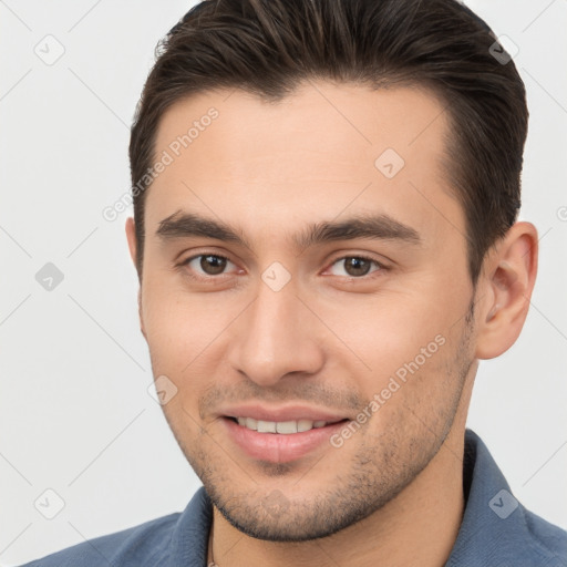 Joyful white young-adult male with short  brown hair and brown eyes