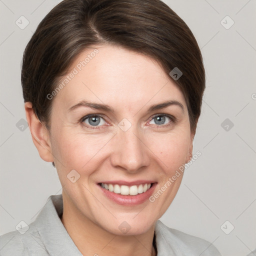 Joyful white young-adult female with short  brown hair and grey eyes