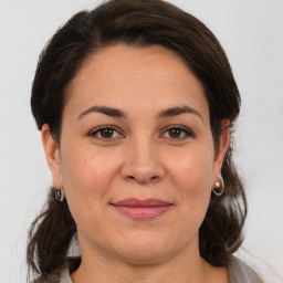 Joyful white adult female with medium  brown hair and brown eyes