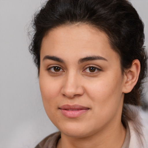 Joyful latino young-adult female with medium  brown hair and brown eyes