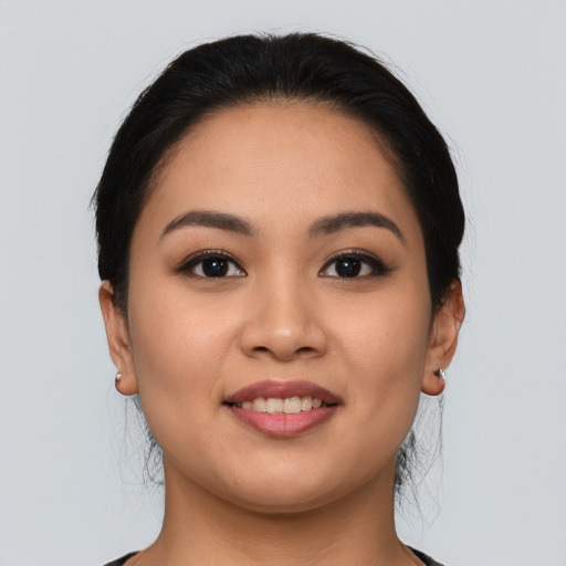 Joyful asian young-adult female with long  black hair and brown eyes