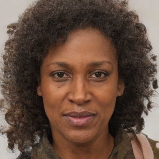 Joyful black adult female with short  brown hair and brown eyes