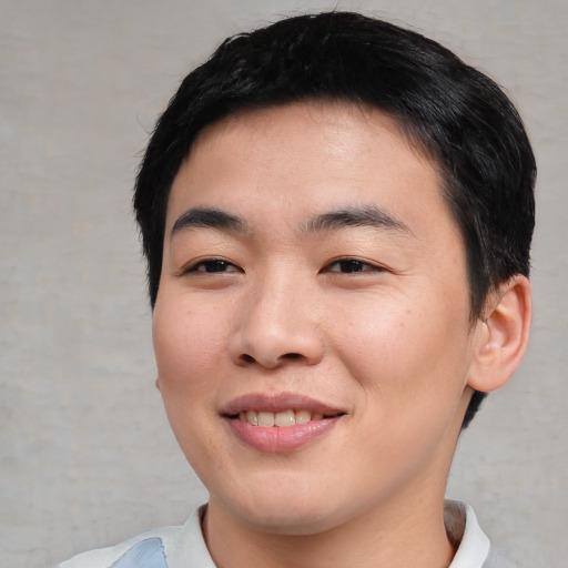 Joyful asian young-adult male with short  black hair and brown eyes