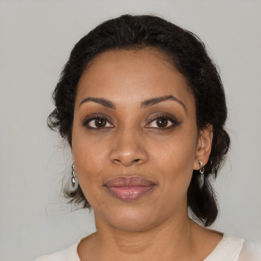 Joyful black young-adult female with medium  black hair and brown eyes