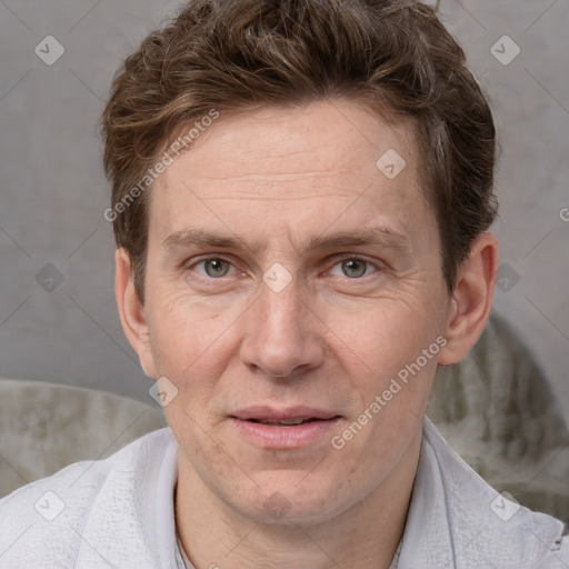 Joyful white adult male with short  brown hair and grey eyes