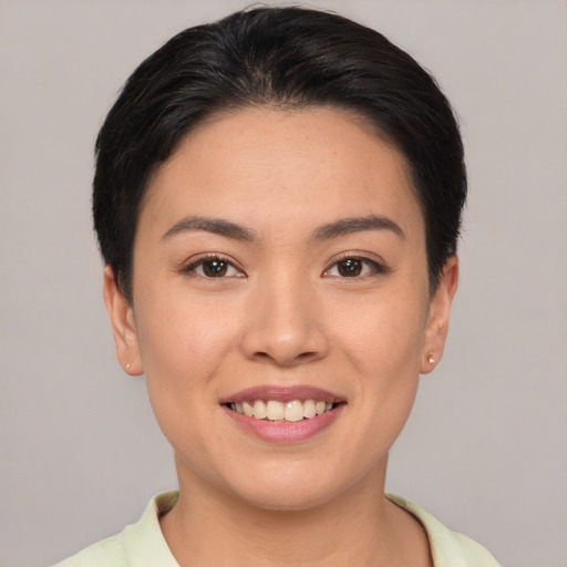 Joyful asian young-adult female with short  brown hair and brown eyes