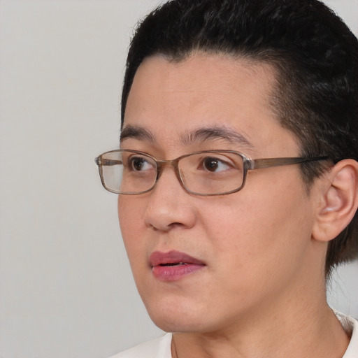 Joyful asian adult female with short  brown hair and brown eyes