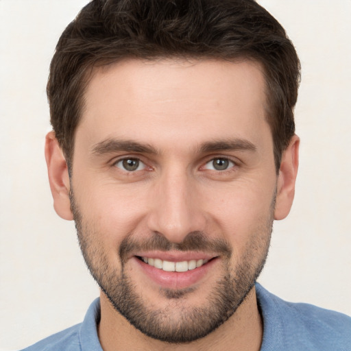 Joyful white young-adult male with short  brown hair and brown eyes