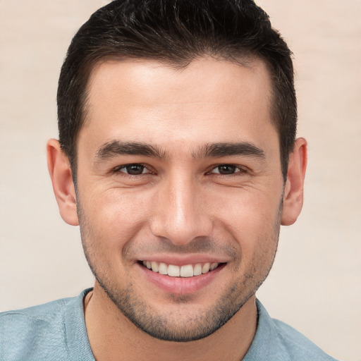 Joyful white young-adult male with short  brown hair and brown eyes