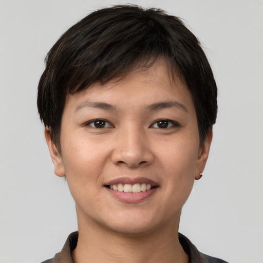 Joyful asian young-adult female with short  brown hair and brown eyes
