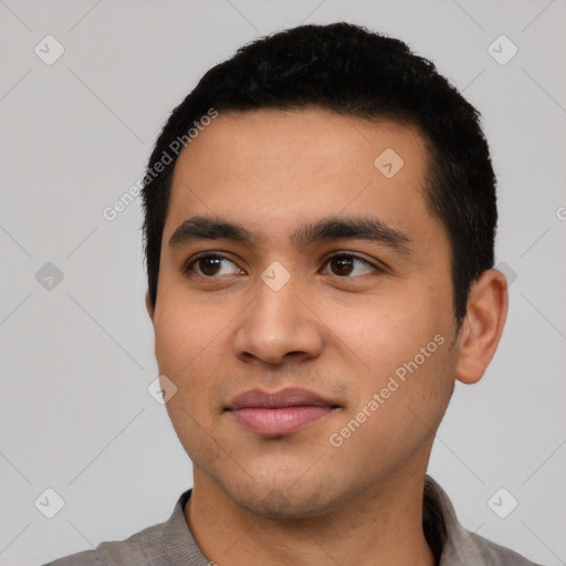 Joyful latino young-adult male with short  black hair and brown eyes