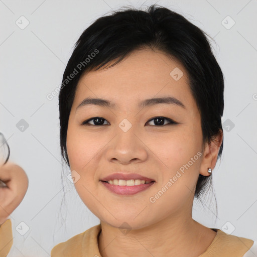 Joyful asian young-adult female with medium  black hair and brown eyes