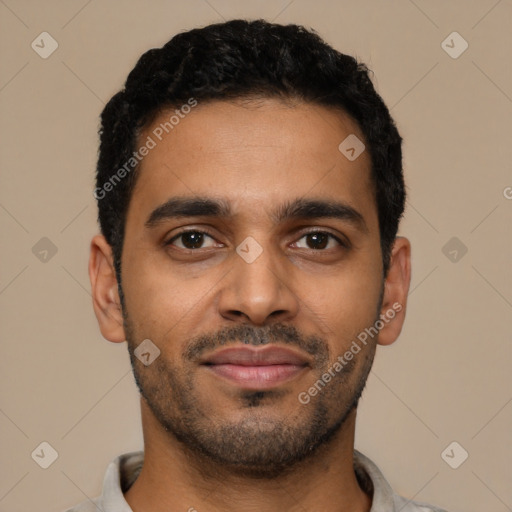 Joyful black young-adult male with short  black hair and brown eyes