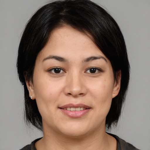 Joyful asian young-adult female with medium  black hair and brown eyes