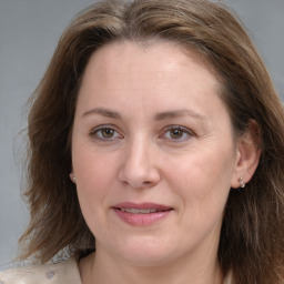 Joyful white adult female with medium  brown hair and grey eyes